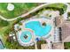 Expansive community pool with lounge chairs, hot tub, and adjacent clubhouse at 318 Winding Brook Ln # 104, Bradenton, FL 34212