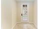 Bright entryway features decorative glass door and neutral tile flooring at 318 Winding Brook Ln # 104, Bradenton, FL 34212