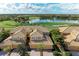 Stunning golf course view with tile roof, lush landscaping, and a tranquil pond at 318 Winding Brook Ln # 104, Bradenton, FL 34212