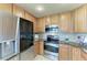 Well-lit kitchen featuring stainless steel appliances and granite countertops at 318 Winding Brook Ln # 104, Bradenton, FL 34212