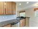 Kitchen sink area with wood cabinets, granite counters, and stainless dishwasher at 318 Winding Brook Ln # 104, Bradenton, FL 34212