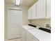 Laundry room with side by side washer and dryer, utility closet, and overhead lighting at 318 Winding Brook Ln # 104, Bradenton, FL 34212