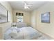 Staged main bedroom featuring a bed with blue throw and art on the walls at 318 Winding Brook Ln # 104, Bradenton, FL 34212