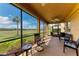 Screened in patio with chairs and a view of the golf course at 318 Winding Brook Ln # 104, Bradenton, FL 34212