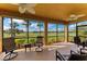 Screened in patio with chairs and a view of the golf course at 318 Winding Brook Ln # 104, Bradenton, FL 34212