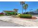 Community tennis center with palms, lush landscaping, and a unique giant tennis ball statue at 318 Winding Brook Ln # 104, Bradenton, FL 34212