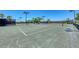 Outdoor tennis courts with nets in a fenced in area with shade and benches at 318 Winding Brook Ln # 104, Bradenton, FL 34212