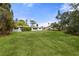 Large, grassy backyard with some trees and a view of the house at 346 Suwanee Ave, Sarasota, FL 34243
