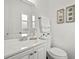Clean and modern bathroom with white vanity, toilet, and mirror at 346 Suwanee Ave, Sarasota, FL 34243