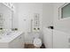 White bathroom featuring a vanity, toilet, and in-unit washer/dryer at 346 Suwanee Ave, Sarasota, FL 34243