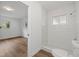 Modern bathroom with white tile shower, toilet, and wood-look flooring at 346 Suwanee Ave, Sarasota, FL 34243