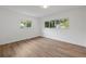Light and airy bedroom featuring large windows and wood-style flooring at 346 Suwanee Ave, Sarasota, FL 34243