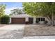 Charming single-story home with a brown garage door, white siding, and landscaped front yard at 346 Suwanee Ave, Sarasota, FL 34243
