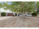 Charming single-story home with white siding, attached garage, and mature trees at 346 Suwanee Ave, Sarasota, FL 34243