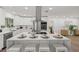 Modern white kitchen featuring stainless steel appliances, a large island with seating, and white cabinetry at 346 Suwanee Ave, Sarasota, FL 34243
