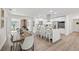Updated kitchen with a breakfast bar, white cabinets, stainless steel appliances, and an adjacent dining area at 346 Suwanee Ave, Sarasota, FL 34243