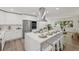 Well-appointed kitchen with stainless steel appliances, a large island, and an open view of the living area at 346 Suwanee Ave, Sarasota, FL 34243