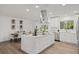 White kitchen with island, stainless steel appliances, and dining area at 346 Suwanee Ave, Sarasota, FL 34243