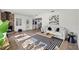 Living room with a brick fireplace, wood floors, and access to the kitchen at 346 Suwanee Ave, Sarasota, FL 34243