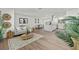 Open-concept living area with wood floors, a comfortable sofa, and stylish decor at 346 Suwanee Ave, Sarasota, FL 34243