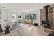 Spacious living room with a large brick fireplace, ample natural light, and wood floors at 346 Suwanee Ave, Sarasota, FL 34243