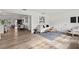 Open living area with wood floors, neutral decor, and view of dining area at 346 Suwanee Ave, Sarasota, FL 34243