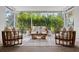Charming sunroom with wicker furniture and lush garden views at 346 Suwanee Ave, Sarasota, FL 34243