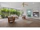 Bright, enclosed sunroom with access to a bedroom and views of greenery at 346 Suwanee Ave, Sarasota, FL 34243