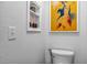 Small bathroom with toilet and decorative wall art at 4106 Central Sarasota Pkwy # 1013, Sarasota, FL 34238
