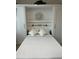 Charming Murphy bed featuring built-in shelving and decorative accents, perfect for a guest room or flexible living space at 4106 Central Sarasota Pkwy # 1013, Sarasota, FL 34238