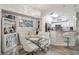 Bright dining area with glass table, white chairs, and a bar cabinet at 4106 Central Sarasota Pkwy # 1013, Sarasota, FL 34238