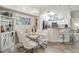 Elegant dining area with glass table and white chairs at 4106 Central Sarasota Pkwy # 1013, Sarasota, FL 34238