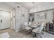 Modern glass dining table with white chairs in a bright space at 4106 Central Sarasota Pkwy # 1013, Sarasota, FL 34238