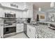Modern kitchen with stainless steel appliances and granite countertops at 4106 Central Sarasota Pkwy # 1013, Sarasota, FL 34238