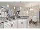 Modern white kitchen with granite countertops and stainless steel appliances at 4106 Central Sarasota Pkwy # 1013, Sarasota, FL 34238