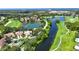 Stunning aerial view of a golf course community with a picturesque lake at 4304 Camino Madera, Sarasota, FL 34238