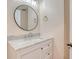 Bathroom with a marble vanity, round mirror, and modern fixtures at 4304 Camino Madera, Sarasota, FL 34238