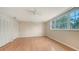 Bedroom with hardwood floors, large window, closet, and ceiling fan at 4304 Camino Madera, Sarasota, FL 34238