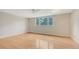 Bedroom with hardwood floors, large window, and ceiling fan at 4304 Camino Madera, Sarasota, FL 34238