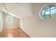 Bonus room or den with hardwood floors, round window, and natural light at 4304 Camino Madera, Sarasota, FL 34238