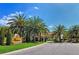Gated community entrance with lush palm trees and elegant signage at 4304 Camino Madera, Sarasota, FL 34238