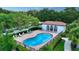 Community pool with a cabana and lounge chairs, surrounded by lush landscaping at 4304 Camino Madera, Sarasota, FL 34238