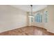 Dining room with large arched windows, tile flooring, and a modern light fixture at 4304 Camino Madera, Sarasota, FL 34238