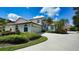 Charming two-story home with a tile roof, attached garage, and lush landscaping at 4304 Camino Madera, Sarasota, FL 34238