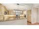 Kitchen featuring stainless steel appliances, granite countertops, and light wood cabinets, adjacent to a laundry room at 4304 Camino Madera, Sarasota, FL 34238