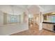 Living room with high ceilings, half wall, and tile flooring adjacent to a staircase at 4304 Camino Madera, Sarasota, FL 34238
