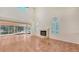 Spacious living area with tile flooring, fireplace, and tall windows offering natural light at 4304 Camino Madera, Sarasota, FL 34238