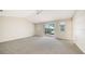 Empty main bedroom with vaulted ceiling, neutral walls, and sliding doors to patio at 4304 Camino Madera, Sarasota, FL 34238