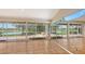 Sunroom with tile flooring, large windows, and a hot tub overlooking a golf course at 4304 Camino Madera, Sarasota, FL 34238