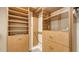 Walk-in closet with built-in wooden shelves, drawers, and hanging rods at 4304 Camino Madera, Sarasota, FL 34238